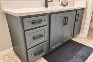 Gray color cabinets under the sink with good looking door